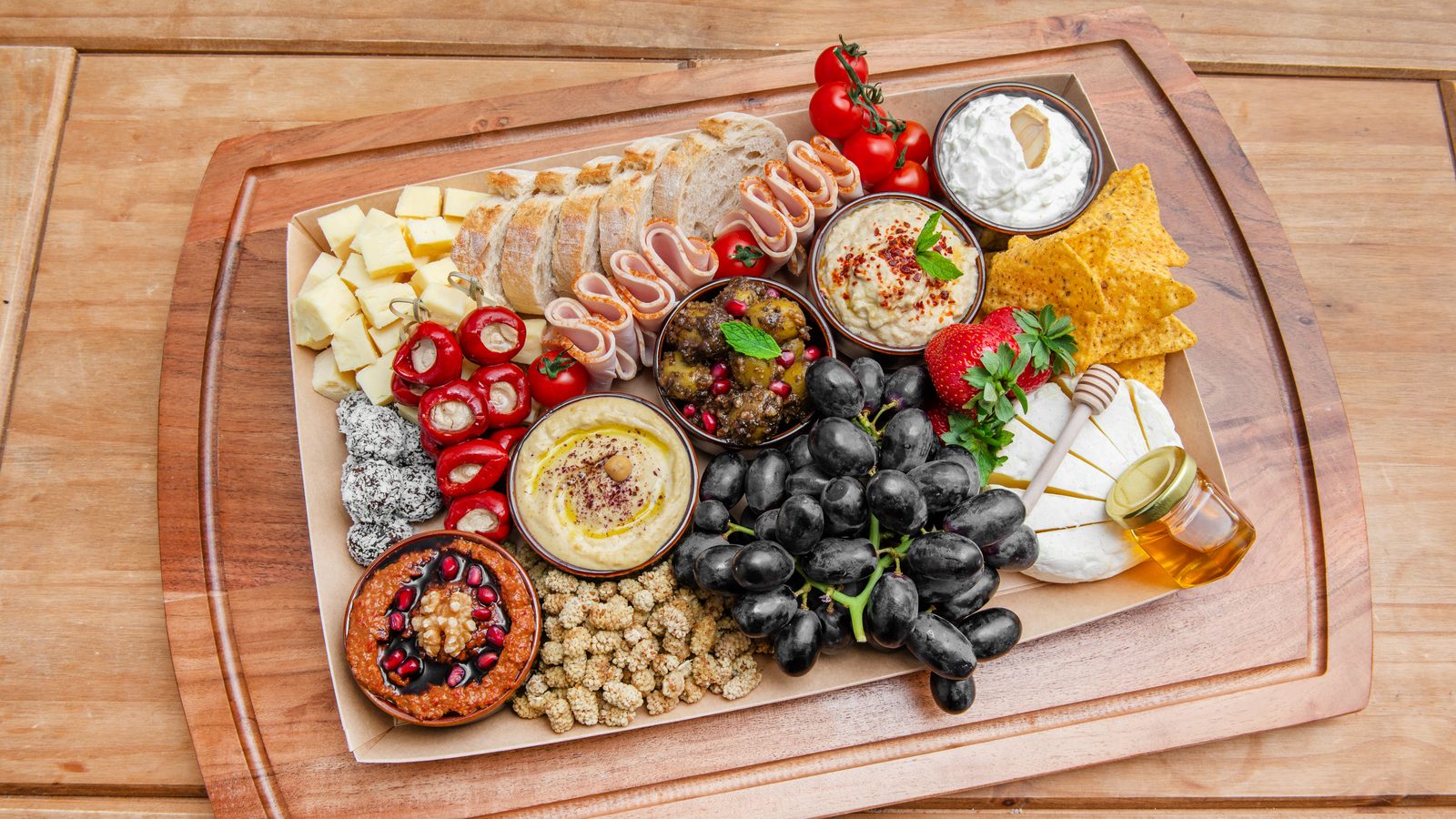 The Gathering Platter — five dips, cheeses, halal turkey, mulberries, grapes and bread