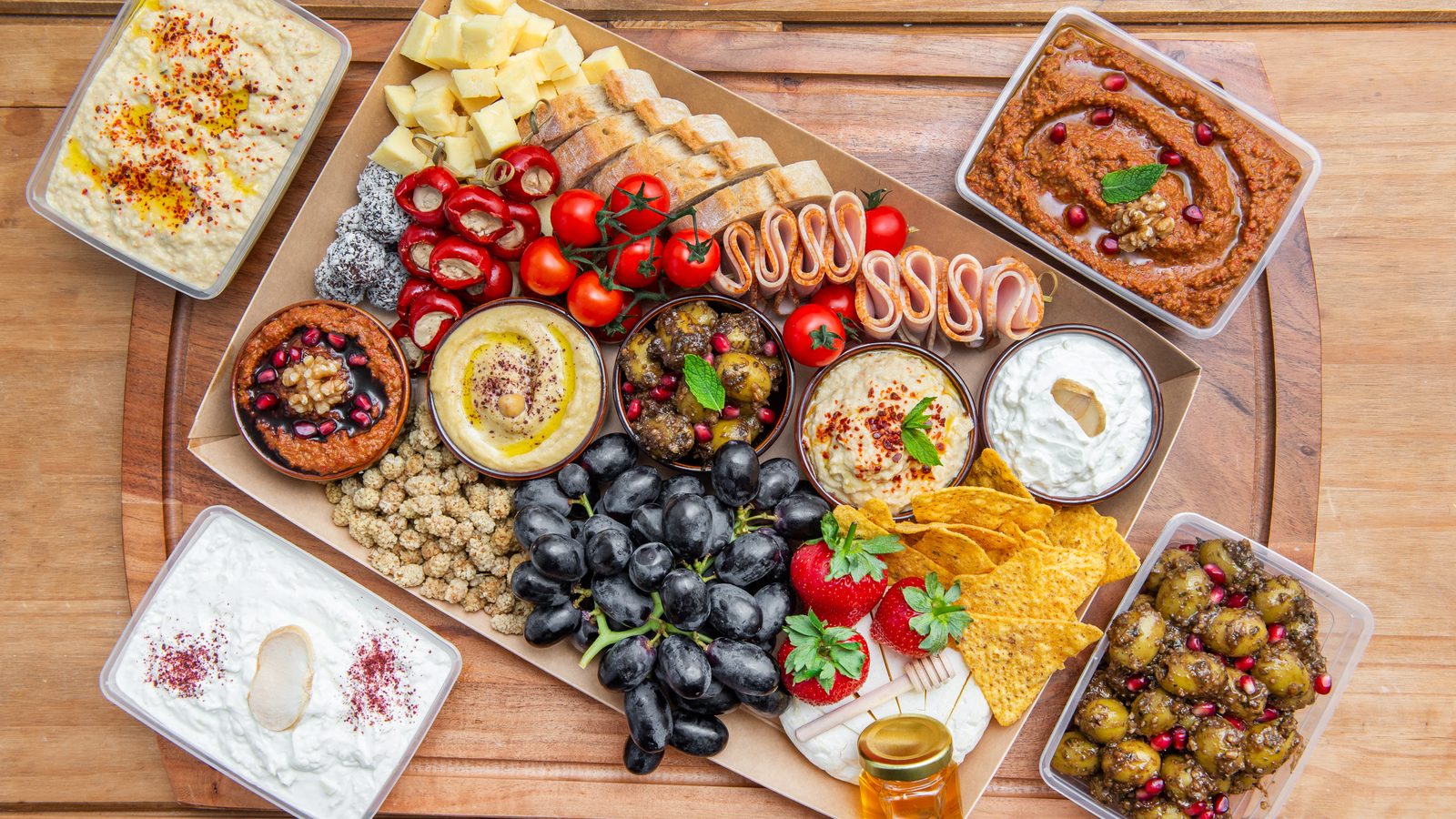 A Mezze Club grazing platter with five handmade dips, cheeses, fruit and bread